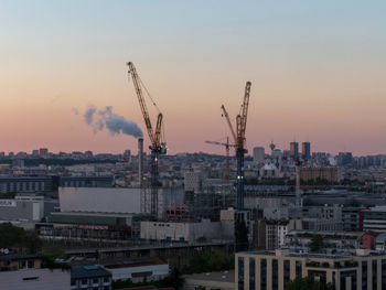 Buildings in city against sky during sunset