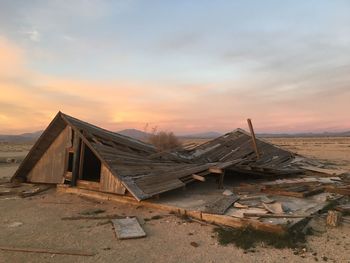 Collapsed house on barren landscape