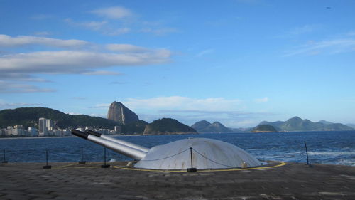 Cannon by sea against sky at fort copacabana