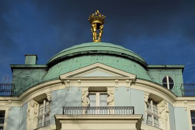 Low angle view of statue against blue sky