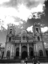 Low angle view of building against cloudy sky