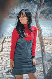 Young woman standing at beach