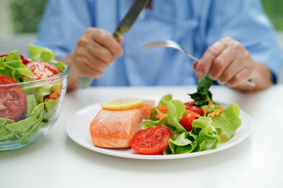 Midsection of man preparing food on table