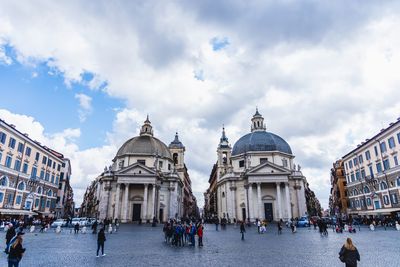 Group of people in front of buildings in city