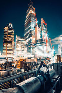 Low angle view of illuminated buildings against sky at night