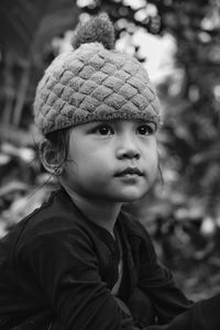 Close-up portrait of cute boy looking away outdoors