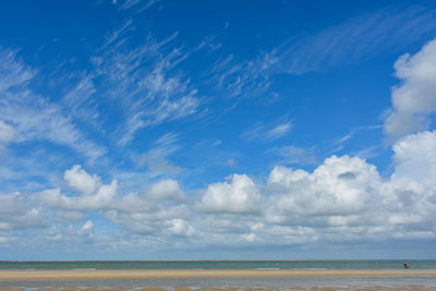 Beach by the sea with clouds on the blue sky