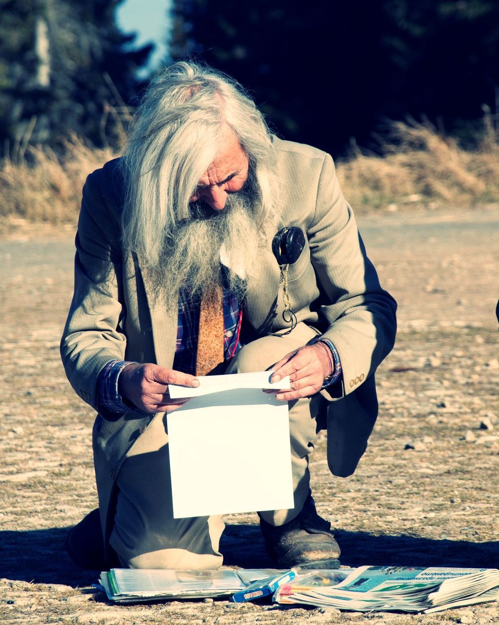 FULL LENGTH OF A MAN HOLDING PAPER