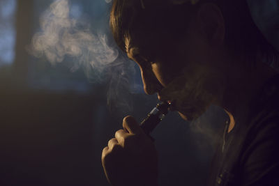Close-up of man smoking hookah pipe
