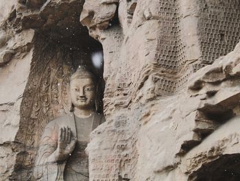 Statue against historic building