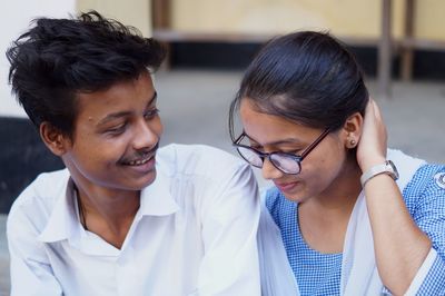 Smiling man and woman in school uniform