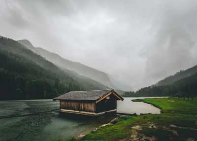 Built structure by lake against sky