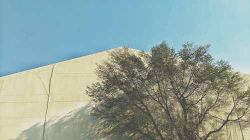 Low angle view of built structure against clear blue sky