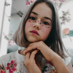 Close-up portrait of girl with colorful face paint