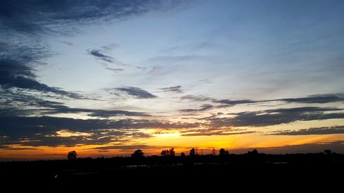 Silhouette landscape against sky during sunset