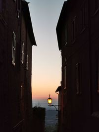 Low angle view of buildings against sky during sunset