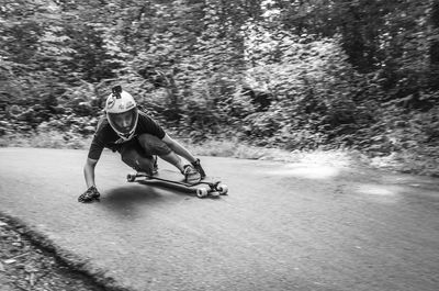 Man skateboarding on road