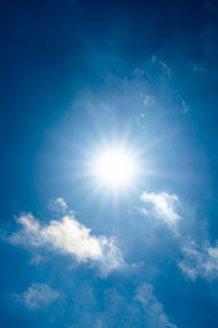 Low angle view of blue sky on sunny day