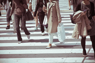 Low section of business people walking on road