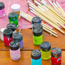 High angle view of multi colored bottles on table