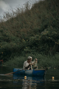 People sitting on boat in lake