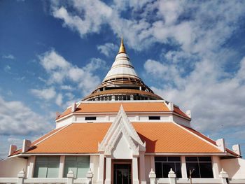 Low angle view of building against cloudy sky