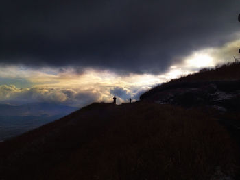 Scenic view of mountains against cloudy sky