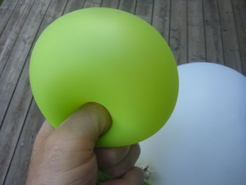 Close-up of hand holding balloons