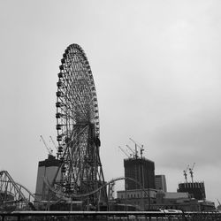 Low angle view of ferris wheel against sky