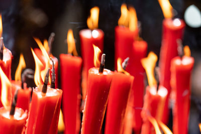 Close-up of lit candles in temple