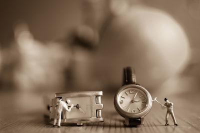 Close-up of figurines and wristwatches on table