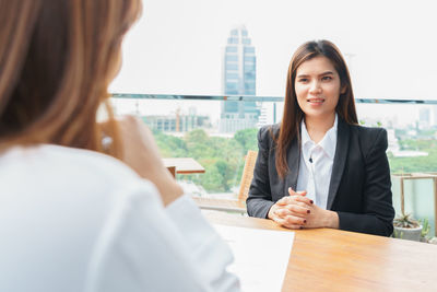 Portrait of a beautiful young woman on table