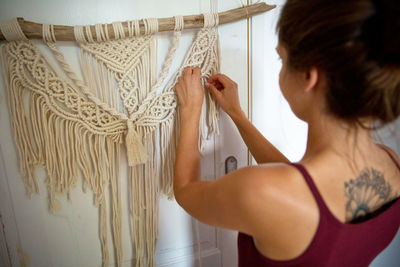 Rear view of woman standing at home