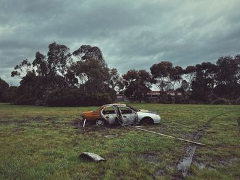 Car on field against sky