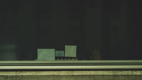 Building seen through train window at night