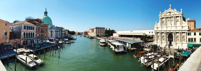 Boats in canal amidst buildings in city