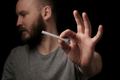 Hands bearded man with cigarette, close up. give up smoking cigarettes. 