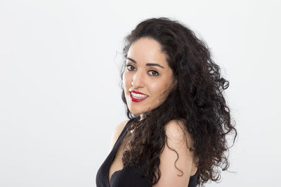 Portrait of young woman against white background