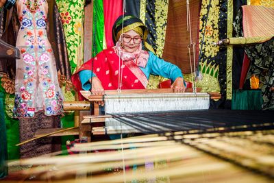 A grandmother who is still passionate about woven songket in pandai sikek, sumatra barat