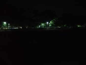 Illuminated buildings against sky at night