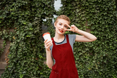 Portrait of smiling young woman standing outdoors