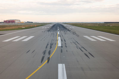 View of airplane at airport runway against sky