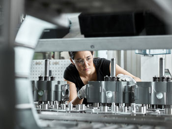 Young woman checking production line on a conveyor belt