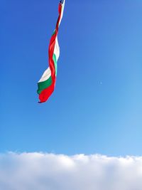 Low angle view of flag against blue sky