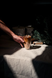 Hand holding coffee cup on table