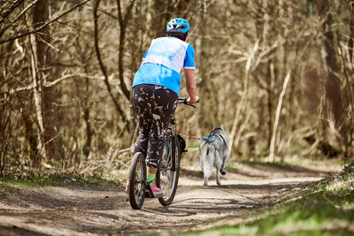 Rear view of man riding bicycle