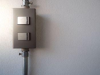 Close-up of electric lamp on wall