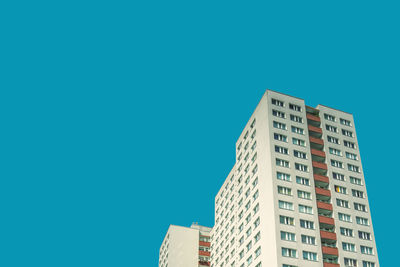 Low angle view of buildings against clear blue sky