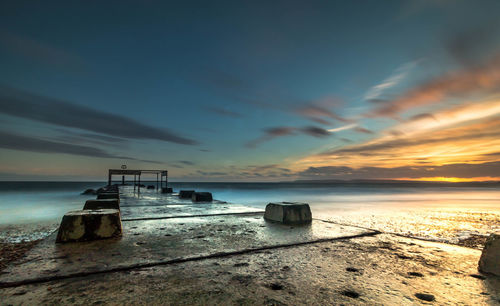 Scenic view of sea against sky at sunset