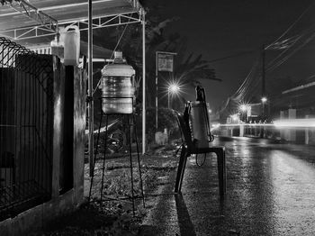 Man sitting on street at night